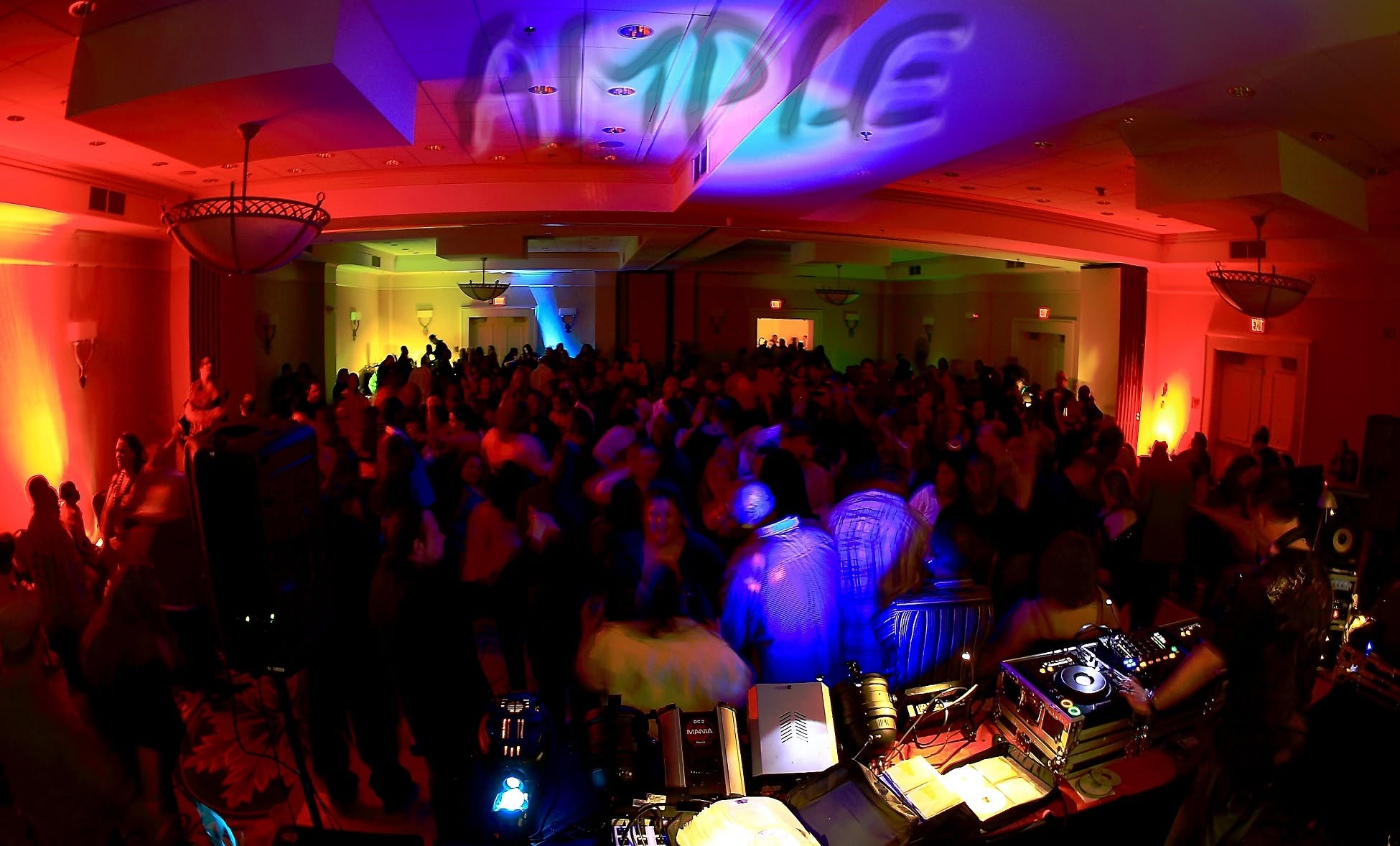 A packed Club Ample ballroom in Rocky Hill with the DJ booth in the foreground and AMPLE projected above the dance floor